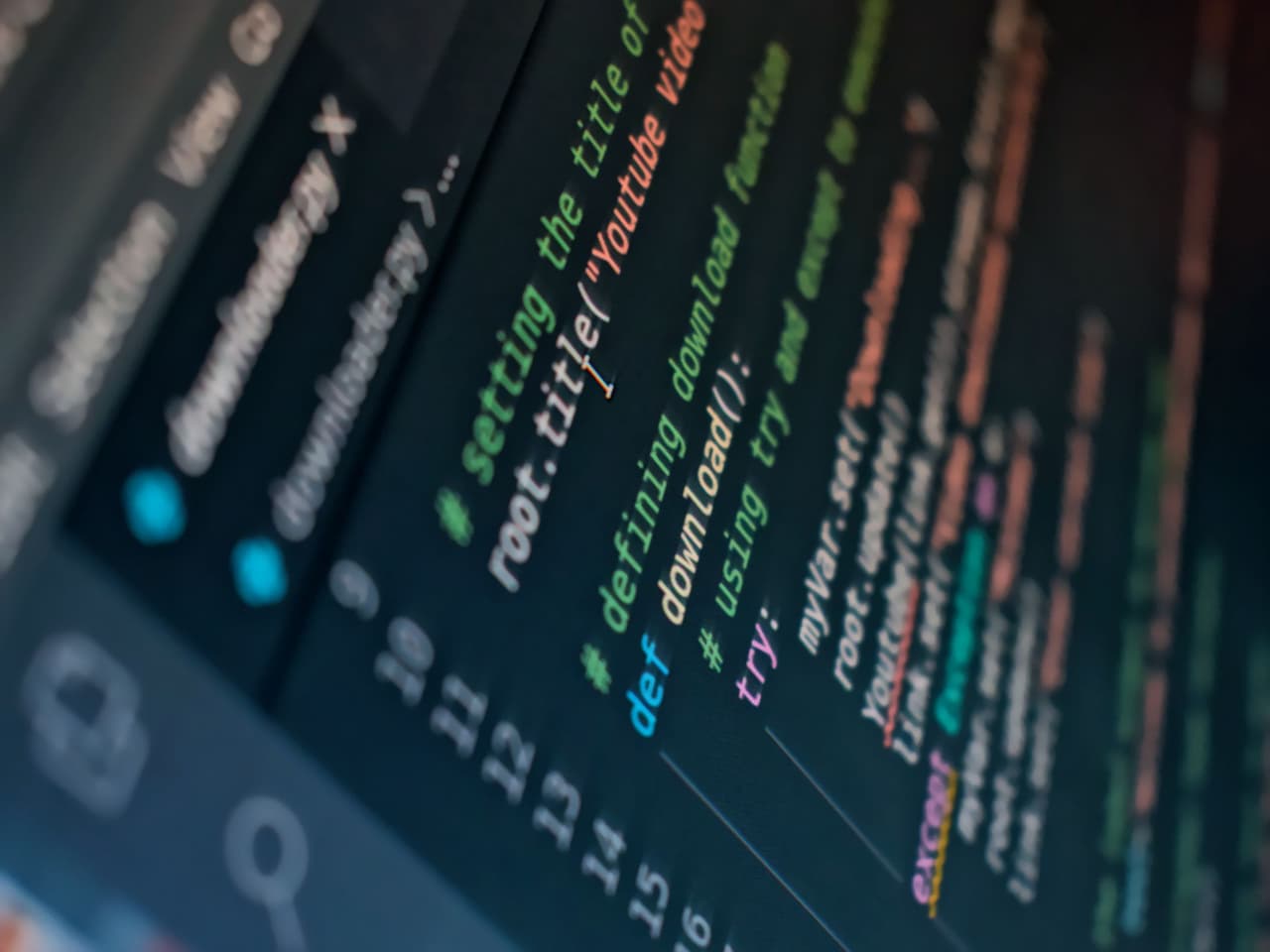A monitor at an angle showing coloured source code